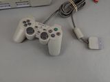 a video game controller sitting on a table next to a laptop