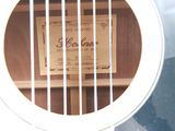 a white guitar with a label on the back of it