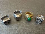 five different rings are sitting on top of a leather surface