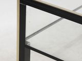 a close up of a glass and metal coffee table on a white background