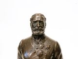 a bronze statue of a man with a beard