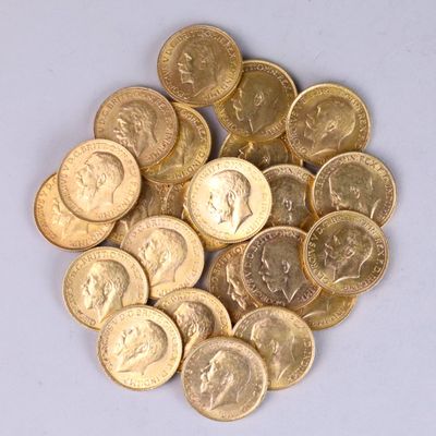a pile of gold coins on a white surface