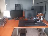 a desk with two monitors and a keyboard on it