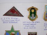 many different badges on a piece of paper on the wall