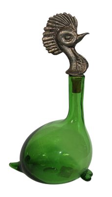 a green glass bottle with a bird on top of it