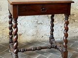 a small wooden table with a drawer on top of it