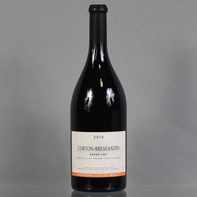 a bottle of red wine sitting on top of a glass table