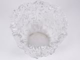 a close up of a clear glass bowl on a white surface