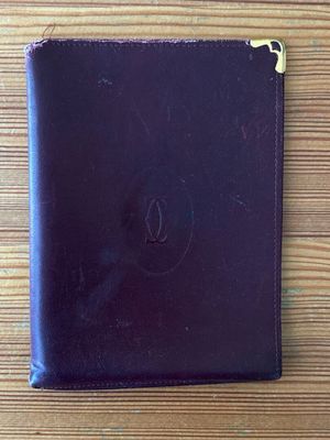 purple leather ipad case on wooden table with apple logo