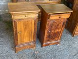 two wooden nightstands sitting next to each other on the ground