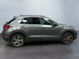 the rear end of a gray volkswagen suv parked in a garage