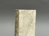 an old book sitting on top of a gray surface