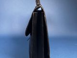 an image of a small black bag on a blue background