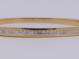 a close up of a gold ring with diamonds on it