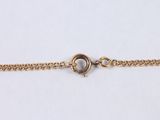 a close up of a gold chain bracelet with a clasp