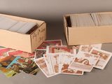 two boxes of cards sitting on top of a table next to each other