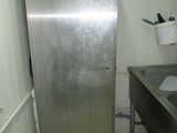 a stainless steel refrigerator in the corner of a kitchen