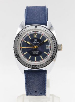 an image of a watch with a blue strap on a white surface