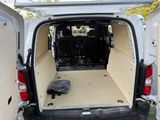 a white van with the back door open and the back of the van is empty