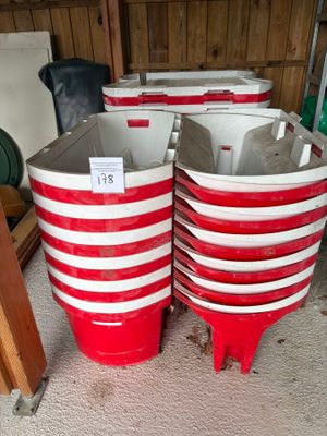 four red and white buckets stacked on top of each other