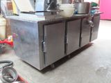 a stainless steel kitchen island with pots and pans on it