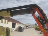 a crane that is sitting in the middle of a parking lot