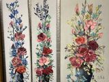three paintings of flowers in a vase on a shelf