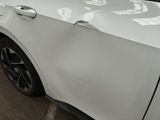 a white car parked in a parking lot with stickers on the side of it