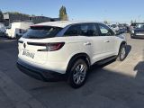 the rear end of a white suv parked in a parking lot