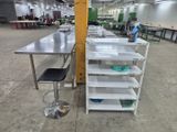 a long table with two stools in the middle of the room