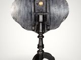 an image of a metal object on a tripod stand on a white background