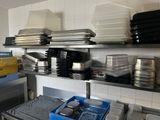 many plates and pans on the shelves in the kitchen