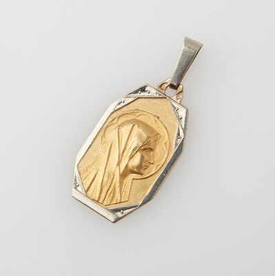 a gold and silver pendant with an image of the virgin mary