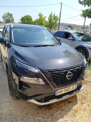 a black nissan suv parked in a parking lot next to other cars