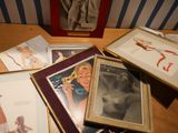 many framed pictures of a woman on a table