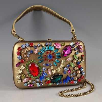 an image of a gold purse with colorful jewels on it
