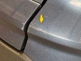 a yellow sticker on the side of a gray car