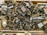 a large pile of old metal parts in a wooden box