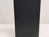 the back of a black desktop computer sitting on top of a white table