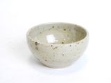 a white bowl that is sitting on a table