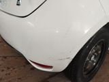 a white car that is parked on the side of the street