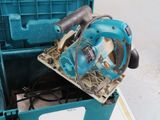 a blue machine that is sitting inside of a box