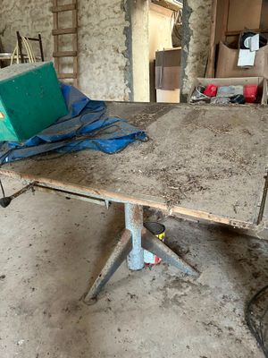 a table that has a laptop on it in a room