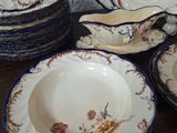 a lot of plates and bowls on the table