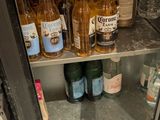 many bottles of beer on the shelves in the refrigerator
