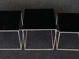 a set of three black and chrome nesting tables