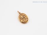 a gold pendant with a picture of the virgin and child