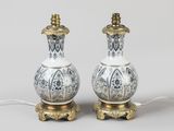 pair of white and gold vases with ornate designs on them