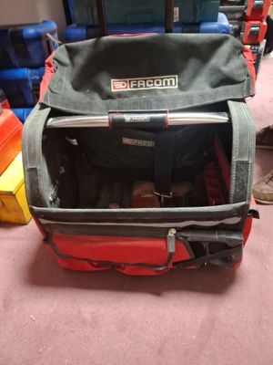 a red suitcase with a laptop in it sitting on the floor