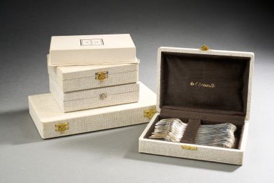 two white boxes with silverware in them sitting on a table